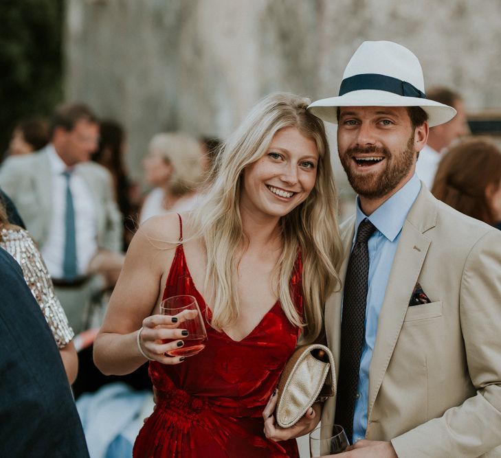 Wedding Guests in Red Dress and Panama Hat