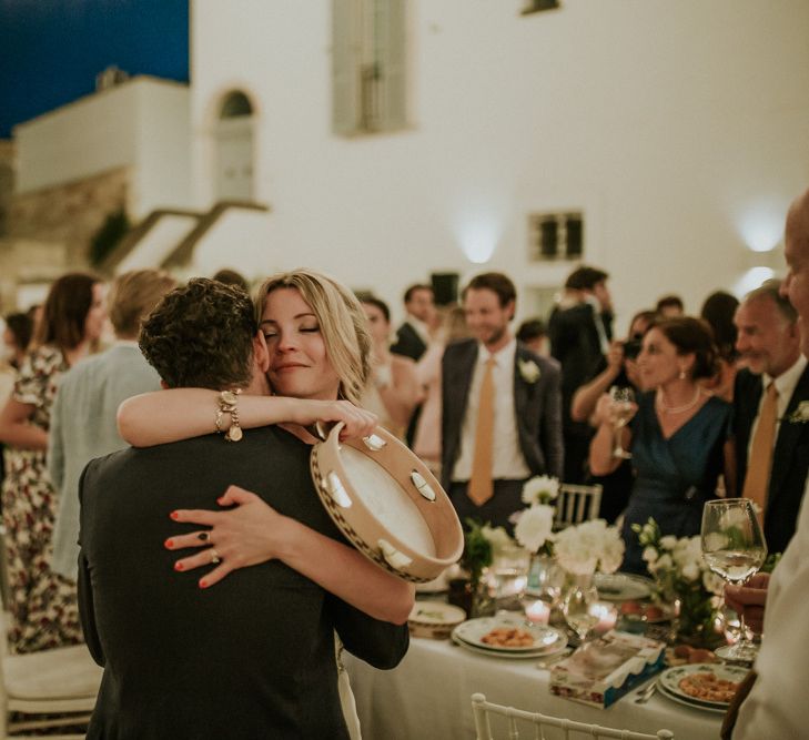 Bride and Groom Hugging at Wedding Reception