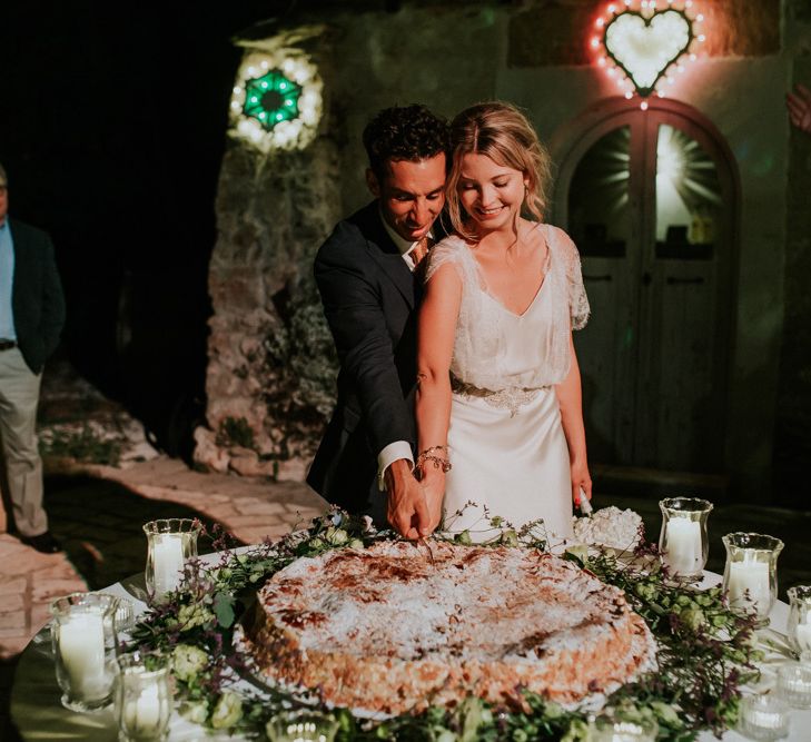 Bride in Halfpenny London Wedding Dress and Groom  in Navy Suit Cutting the Italian Millefoglie Pastry Wedding Cake