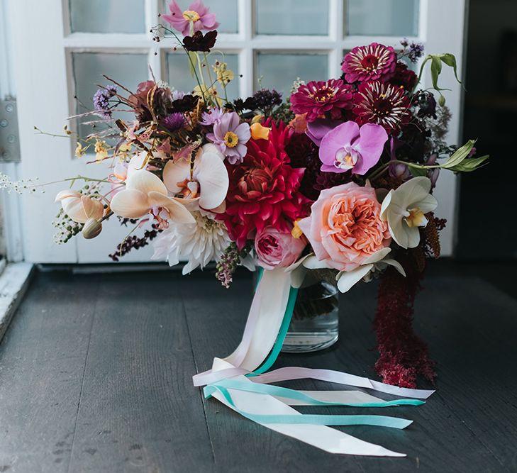 Colourful Deconstructed Bridal Bouquet of Red and Pink Flowers with Trailing Ribbon | Meringue Kisses &amp; Colourful Wedding Flowers &amp; Stationery for a London Wedding at The Globe | Miss Gen