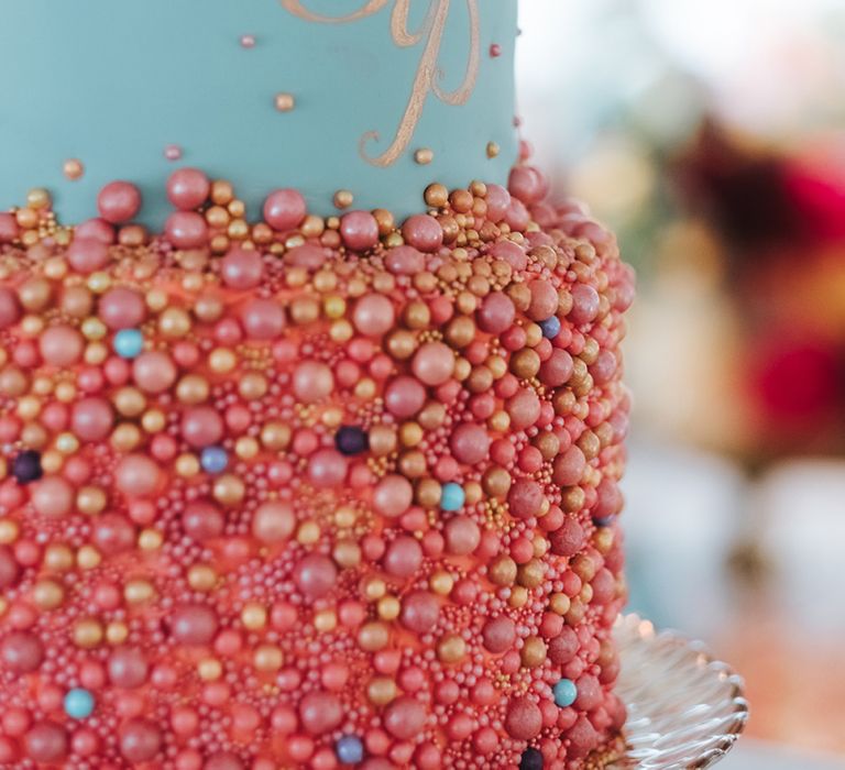 Colourful Three-Tier Wedding Cake with  Duck Egg Blue Icing, Gold Foil Monogram and Pink and Gold Beaded Detail | Meringue Kisses &amp; Colourful Wedding Flowers &amp; Stationery for a London Wedding at The Globe | Miss Gen