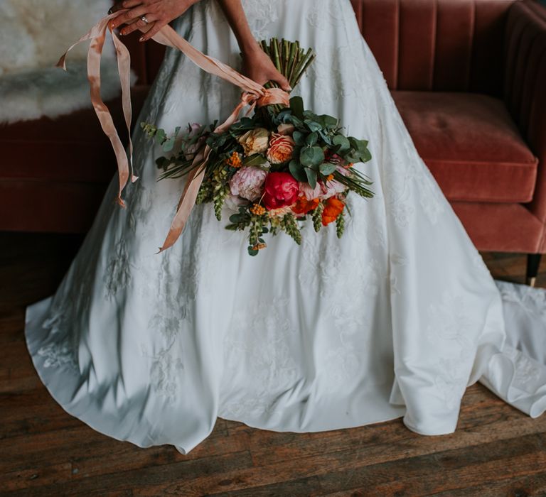 Bright Bridal Bouquet with Foliage and Coral Flowers Tied with Ribbon