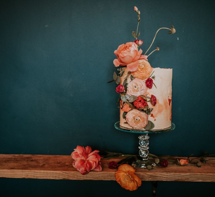 Tall Single Tier Wedding Cake Decorated with Coral Flowers