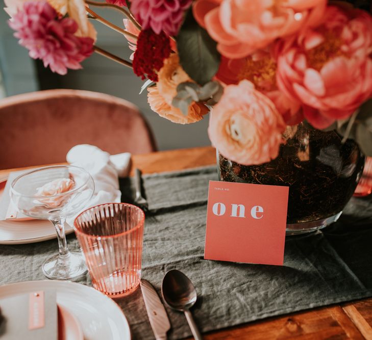 Living Coral Wedding Flowers, Statement Table Number Signs and Coloured Goblet Table Decor