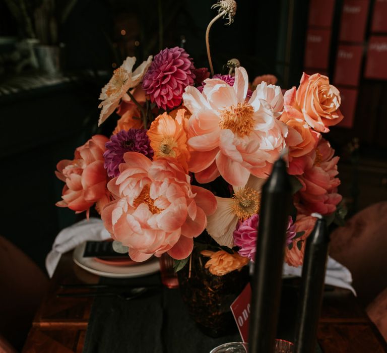 Black Table Runner and Taper Candles against Living Coral Flowers and Tableware