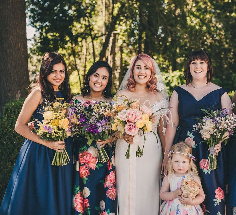 Bridal party in mid-length navy bridesmaid dresses