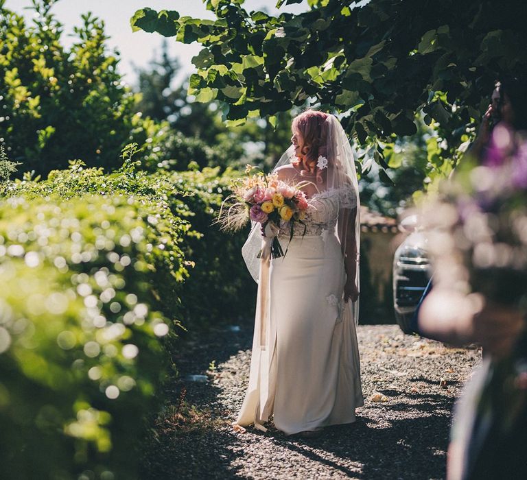 Bride makes her way to outdoor ceremony at Villa di Ulignano