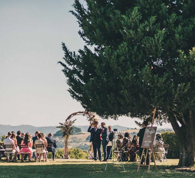 Outdoor wedding ceremony in Tuscany at Villa di Ulignano