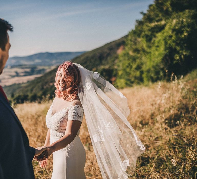 Bride in lace trim veil and groom at Italian wedding