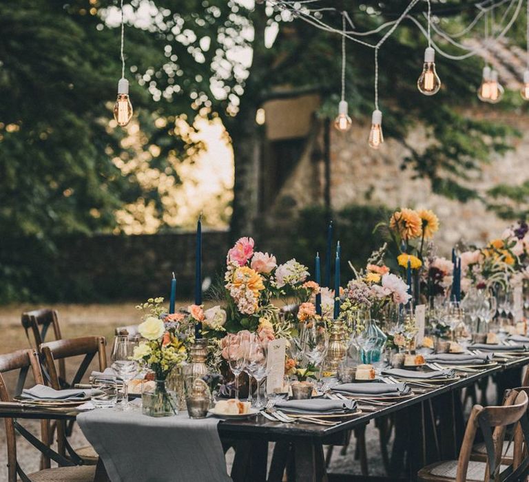 Wedding table decor with pink and yellow flowers at Villa di Ulignano