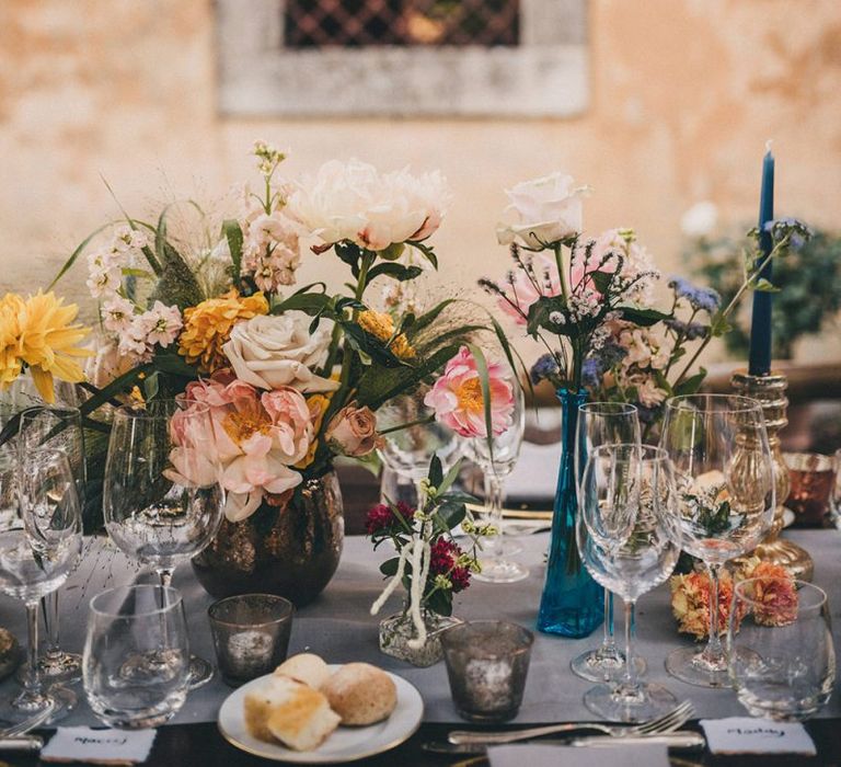 Wedding table decor with pink and yellow flowers at Villa di Ulignano