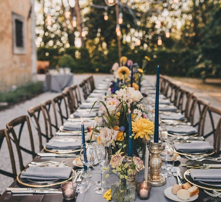 Wedding table decor with pink and yellow flowers at Villa di Ulignano