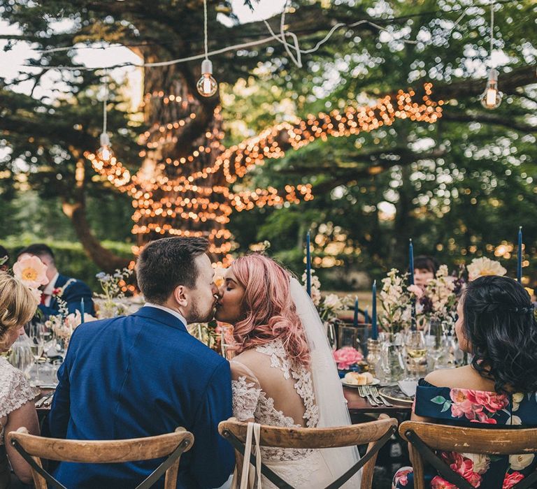 Bride and groom kiss during wedding breakfast at Villa di Ulignano