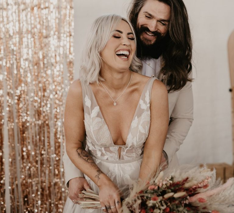 Stylish bride and groom laughing