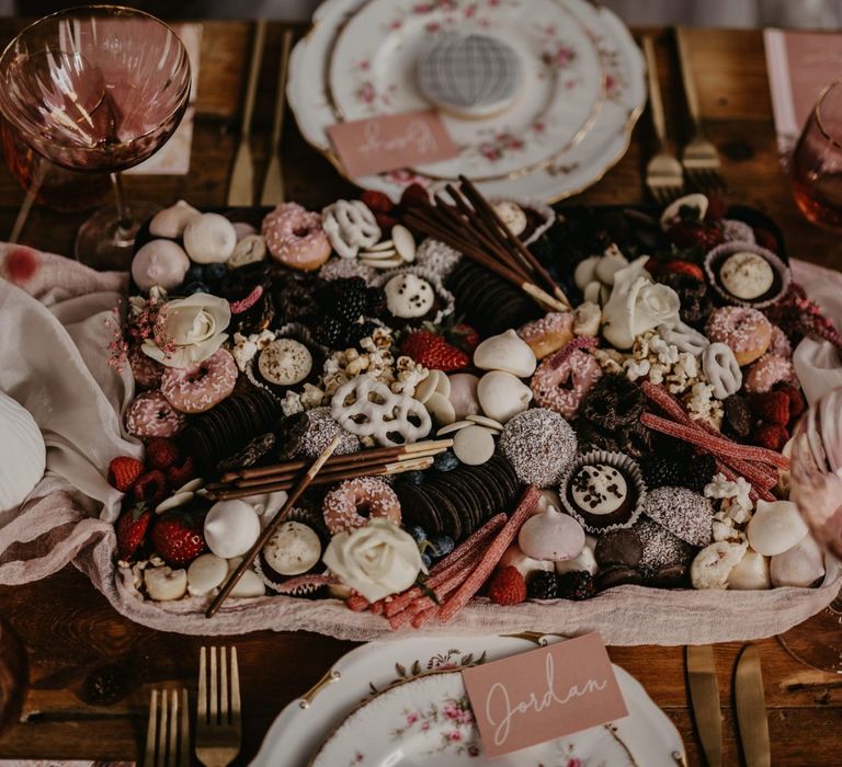 Sweet treat serving platter with macaroons, meringue kisses and mini doughnuts