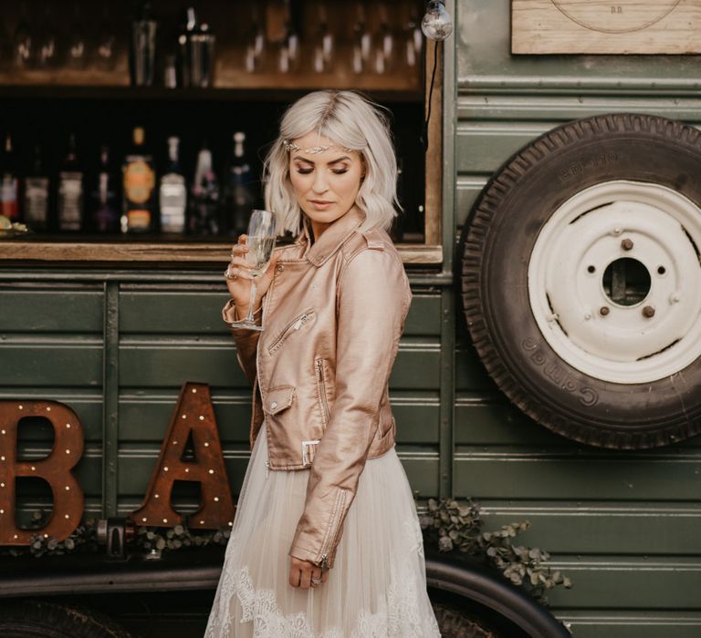 Contemporary bride with blush pink leather jacket and platinum blonde hair