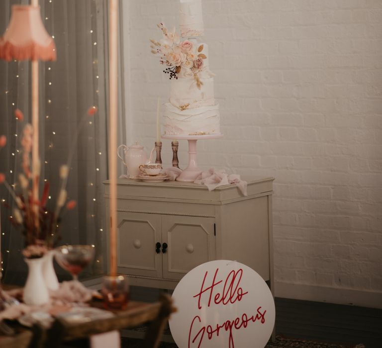 White and pink tall wedding caked with dried flower detail