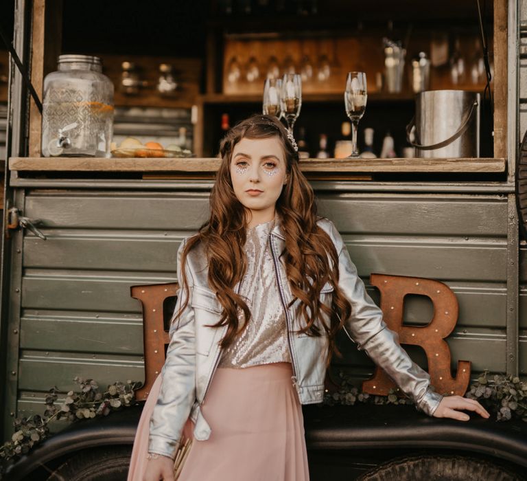 Bridesmaid in pink skirt, silver top and leather jacket