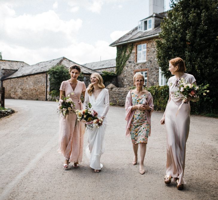 Bridal Party in Blush Pink Dresses Walking to the Wedding Ceremony