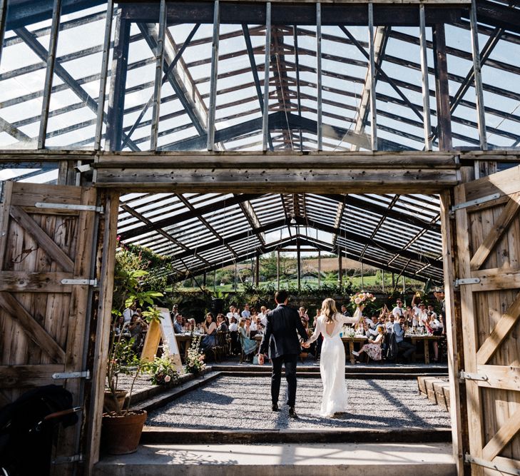 Bride and Groom Entering the Glasshouse Wedding Reception at Anran