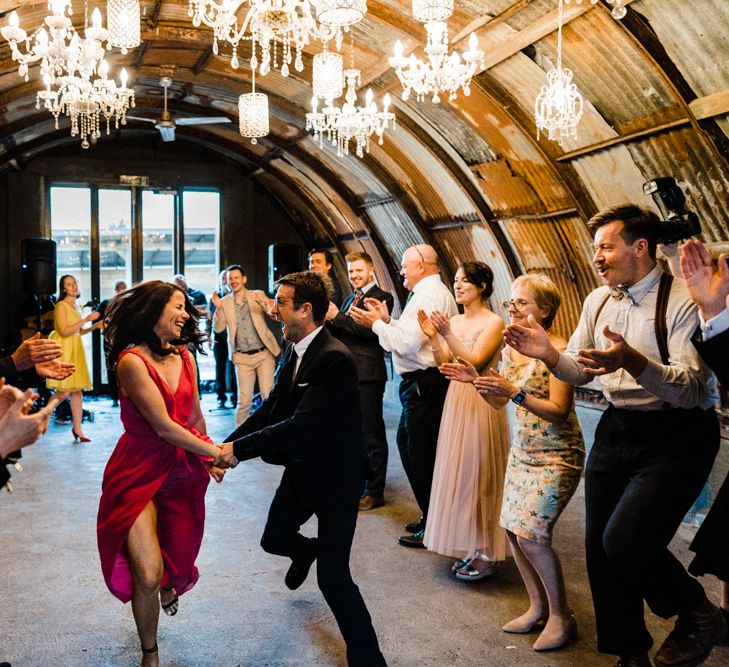 Wedding Guests Dancing Under a Ceiling of Chandeliers