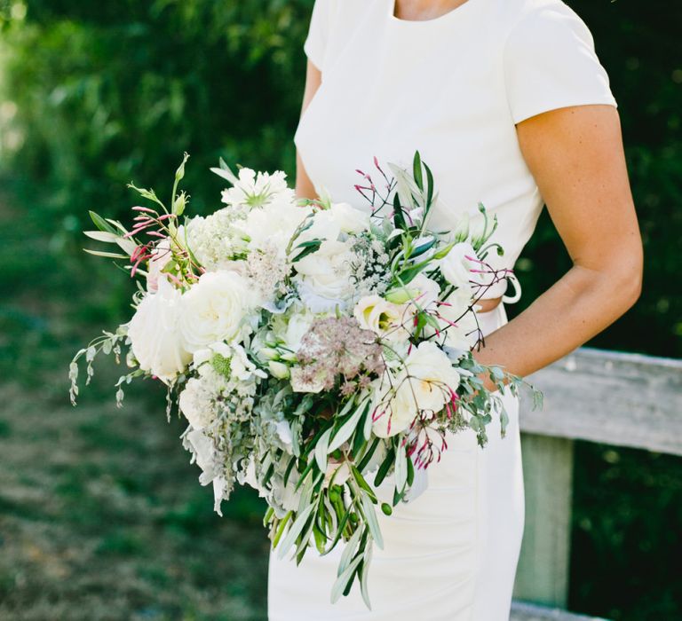 Bride in Fitted Bride in Noel and Jean Bridal Separates Holding Romantic Wedding Bouquet