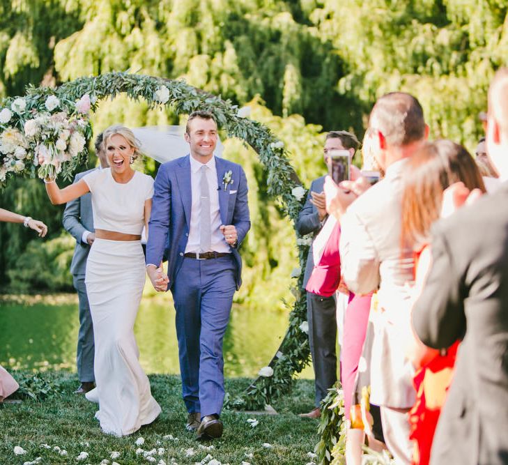 Bride in Fitted Noel and Jean Bridal Separates and Groom in Blue Suit Supply Just Married