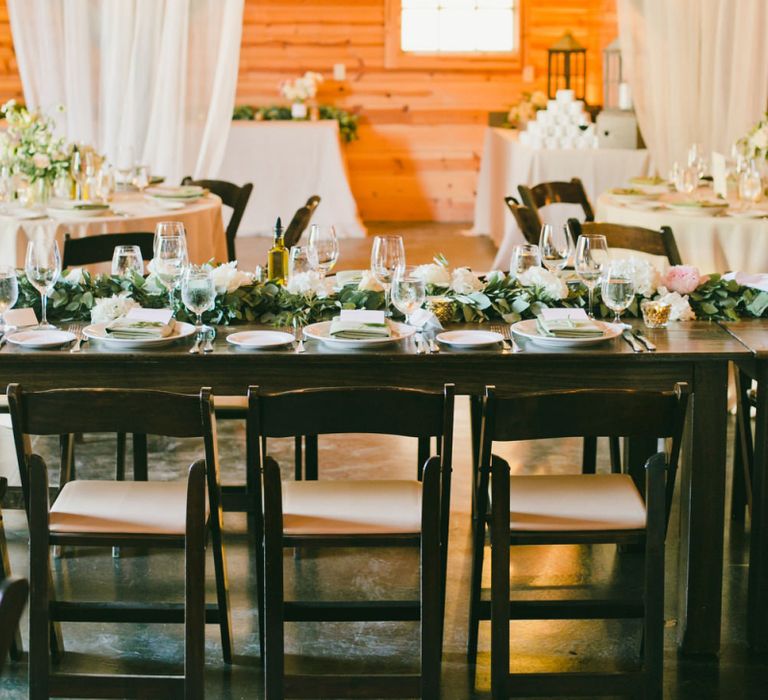 Ranch Wedding Reception Decor including  Drapes and Foliage Flower Arrangements