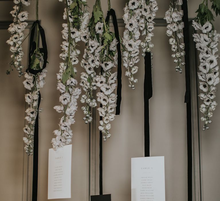 Hanging Anemone Stems with Nat's Paper Studio Stationery Table Plan | Minimalist Monochrome Inspiration with Anemone's &amp; White Genista Flowers styled by The Bijou Bride | Igor Demba Photography | Gione da Silva  Film