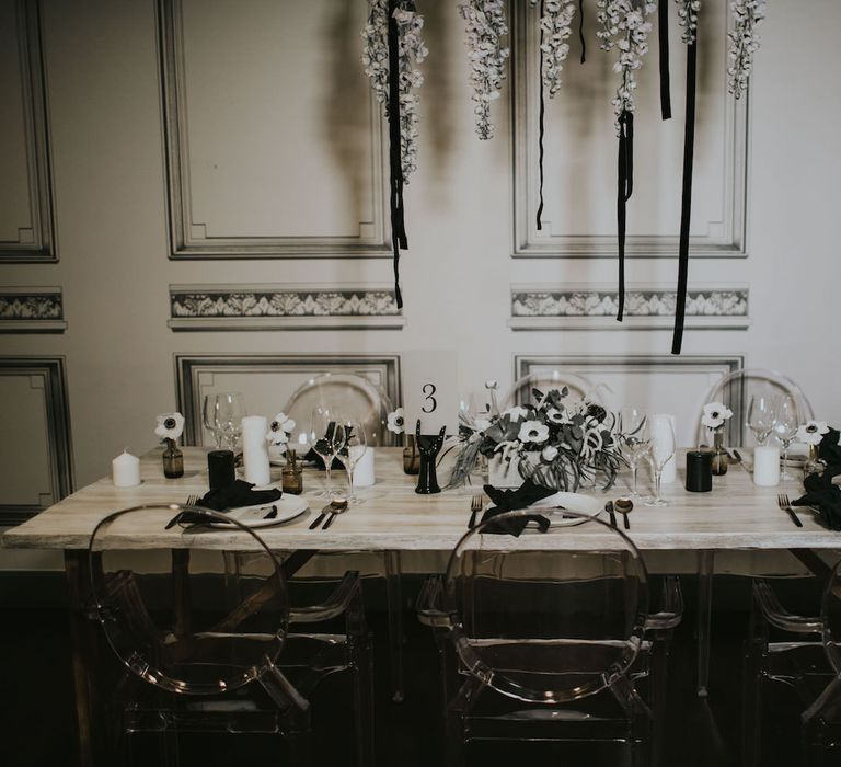 Elegant Tablescape with Ghost Chairs &amp; Hanging Anemone Floral Arrangement | Minimalist Monochrome Inspiration with Anemone's &amp; White Genista Flowers styled by The Bijou Bride | Igor Demba Photography | Gione da Silva  Film