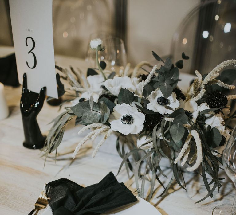 Gold Cutlery &amp; Tassel Name Place Card | Elegant Tablescape with Ghost Chairs &amp; Hanging Anemone Floral Arrangement | Minimalist Monochrome Inspiration with Anemone's &amp; White Genista Flowers styled by The Bijou Bride | Igor Demba Photography | Gione da Silva  Film