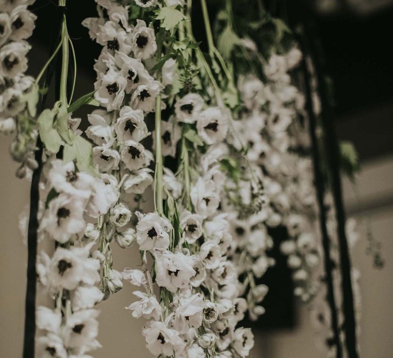 Hanging Anemone Stems Floral Installation | Minimalist Monochrome Inspiration with Anemone's &amp; White Genista Flowers styled by The Bijou Bride | Igor Demba Photography | Gione da Silva  Film