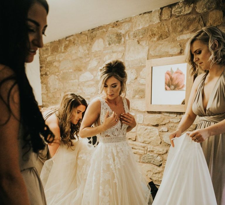 Bride puts on Enzoani wedding dress