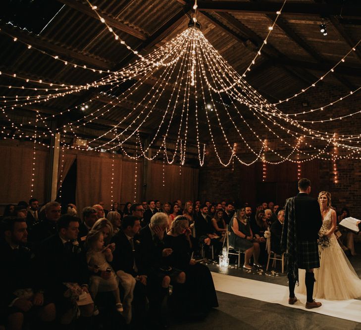 Kinkell Byre wedding ceremony with fairy light canopy and candles