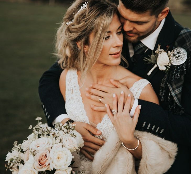 Bride and groom in traditional Scottish kilt