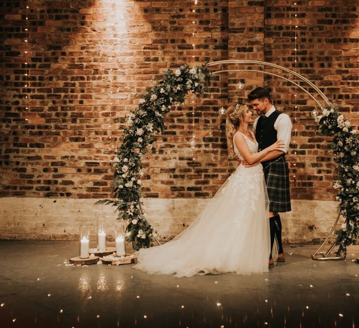 Beautiful flower arch with candles at Kinkell Byre wedding