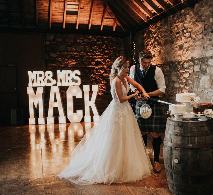 Bride and groom cut the wedding cake