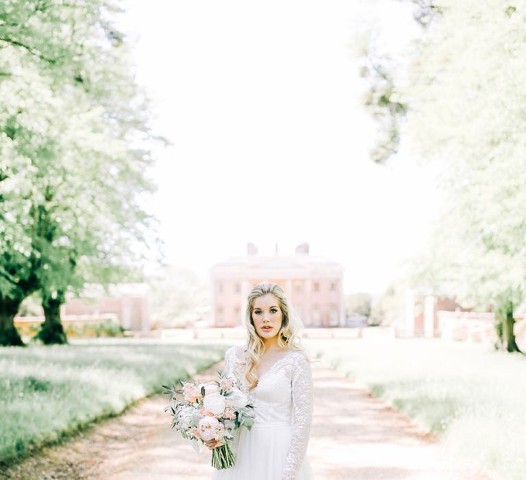 Bride in Lace Wedding Dress Holding White Peony and Peach David Austin Rose Wedding Bouquet