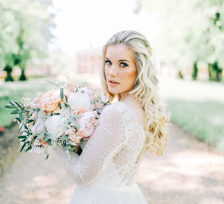 Bride in Lace Wedding Dress Holding White Peony and Peach David Austin Rose Wedding Bouquet