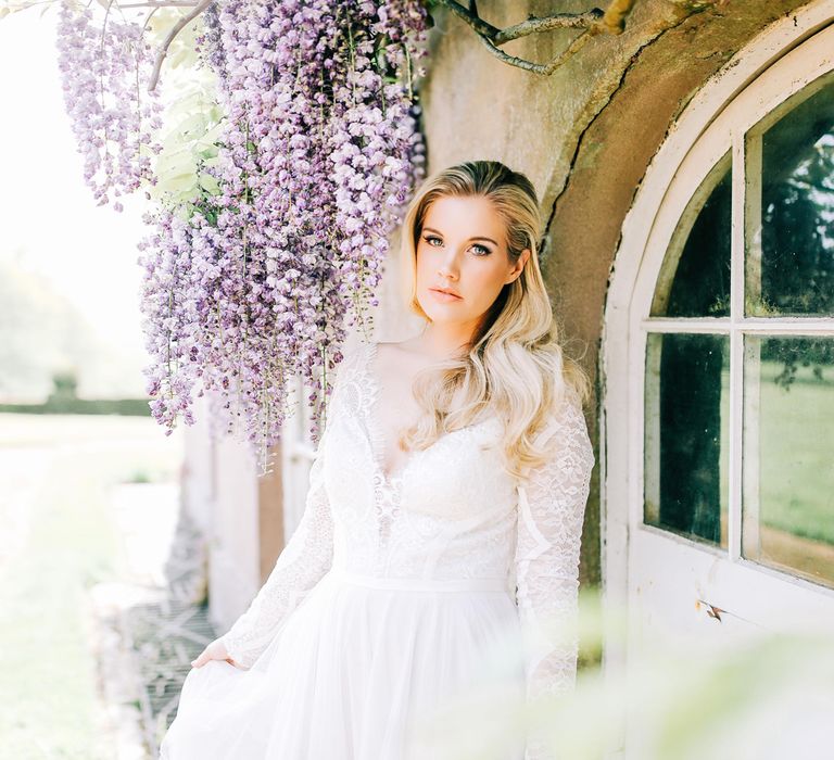 Bride in Lace Long Sleeve Wedding Dress with Half Up Half Down Hairstyle