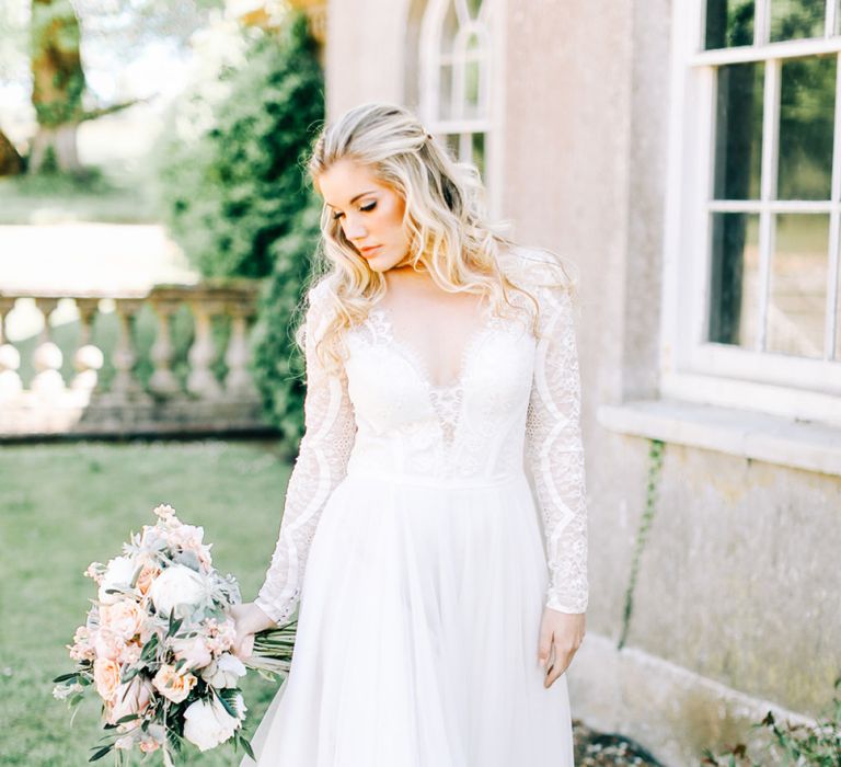 Bride in Romantic Lace Long Sleeve Wedding Dress Holding Peach &amp; Cream Bridal Bouquet