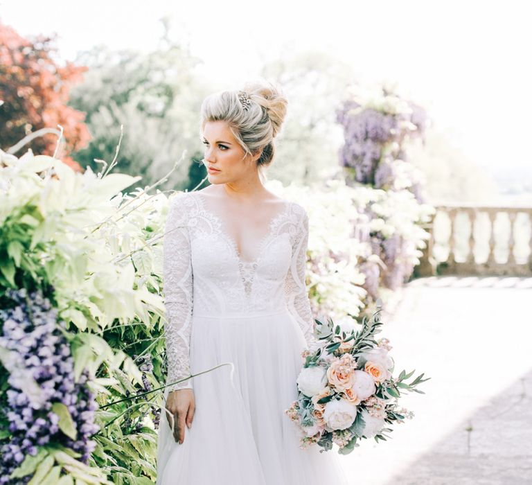 Bride in Lace and Tulle Wedding Dress Holding a Peach and White Wedding Bouquet