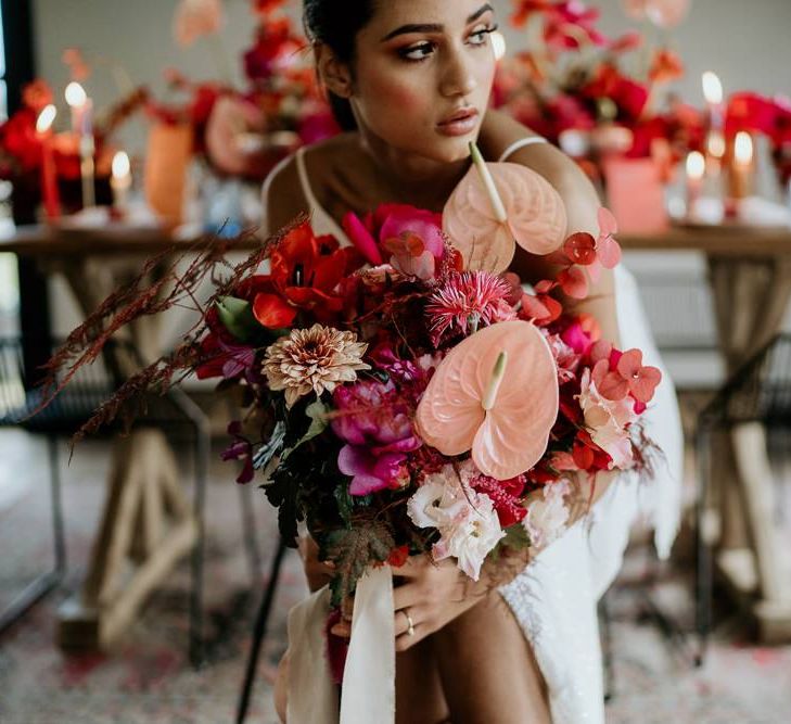 Modern Bride Holding a Pink and Red Wedding Bouquet with Anthurium Flower Stems