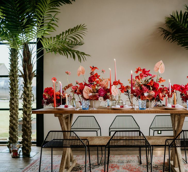 Red and Pink Wedding Flowers with Anthurium Flower Stems, Taper Candles and Coloured Glasses