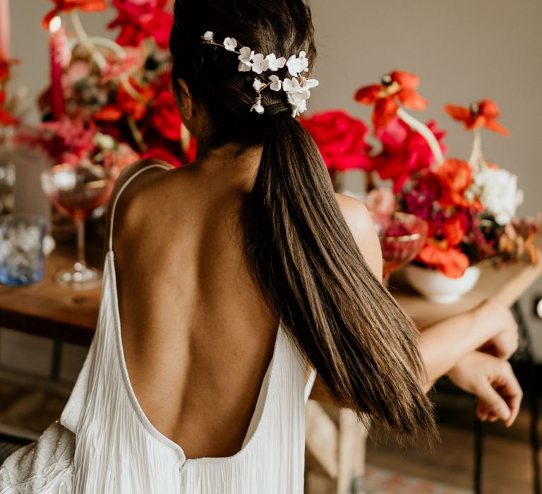 Low Back Fringe Wedding Dress and Sleek Bridesmaid Ponytail with Delicate White Hair Accessory