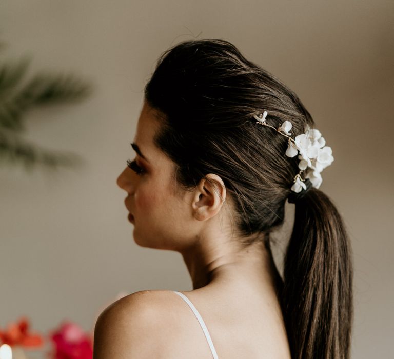 Bride in Minimalist Wedding Dress with Spaghetti Straps and Sleek Ponytail Updo