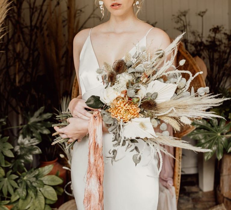 Bride holding a Dried Flower and Grasses Wedding Bouquet