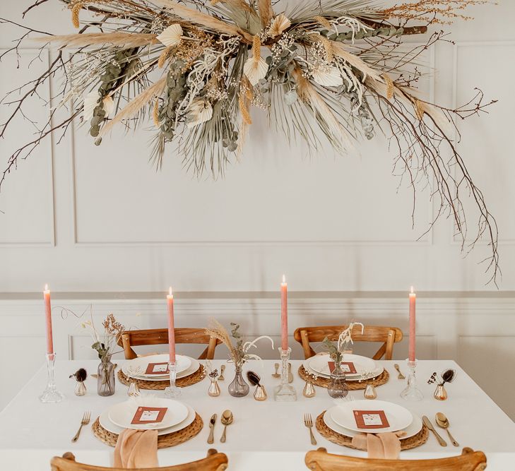 Tablescape Using Natural Wicker Place Mats and Linen, Taper Candles and Small Vessels for Dried Flower Centrepieces