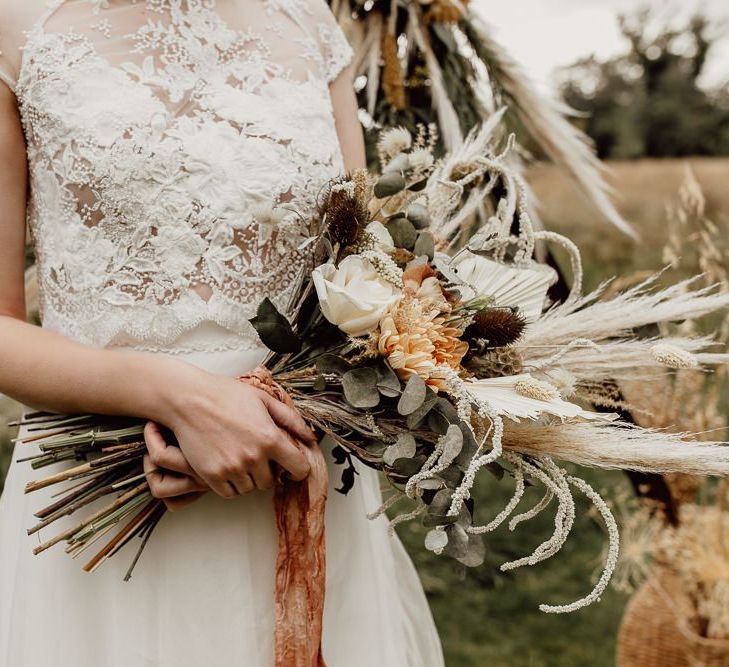 Boho Bride Holding a Bouquet of Dried Flowers and Grasses, Eucalyptus and Orange Flowers