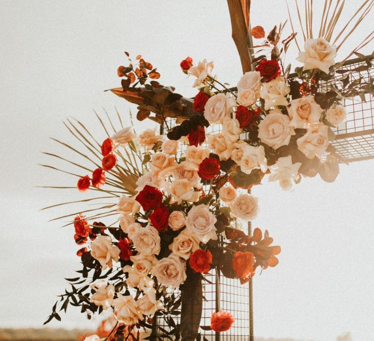 Pink and red wedding ceremony flowers